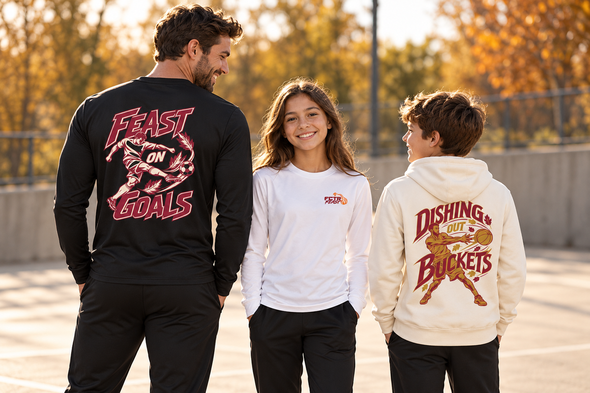 Adult and youth models wearing black and white Feast on Goals long sleeve shirts and the vanilla Dishing Out Buckets hoodie on an autumn sports court