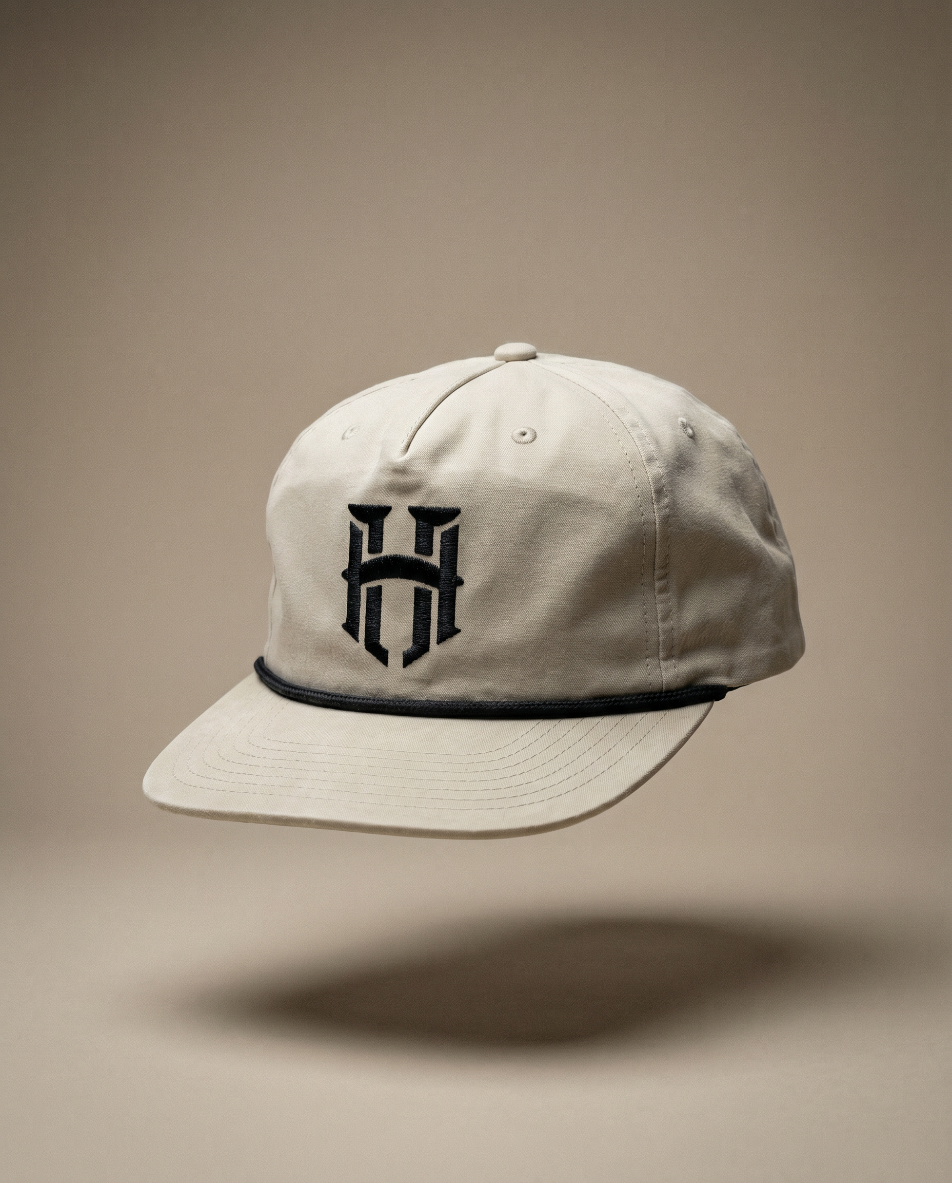 Beige cap with a black logo on a beige background